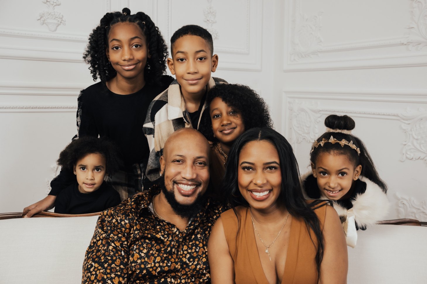 Andrew and his wife with their children gathered closely around them