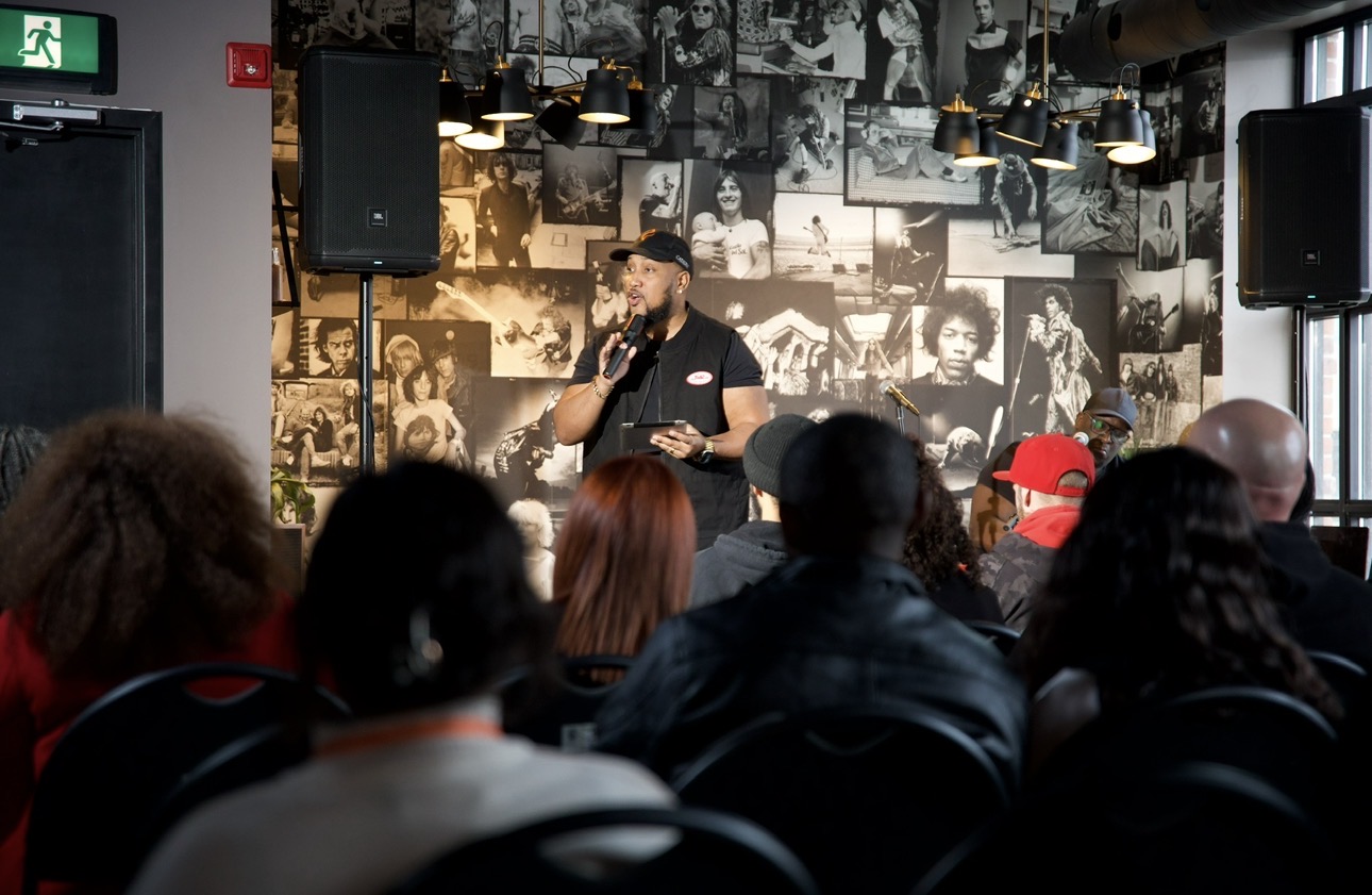 Andrew Alleyne teaching with a microphone to a seated room at Catalyst Church